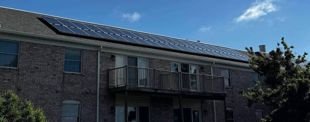 Rooftop solar panels on Cambridge Place Apartments in Iowa City, helping reduce energy costs